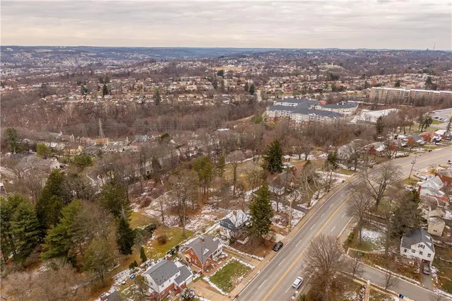 an aerial view of residential houses with city view