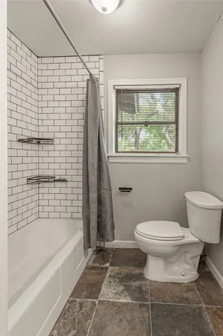 a bathroom with a toilet and a bathtub