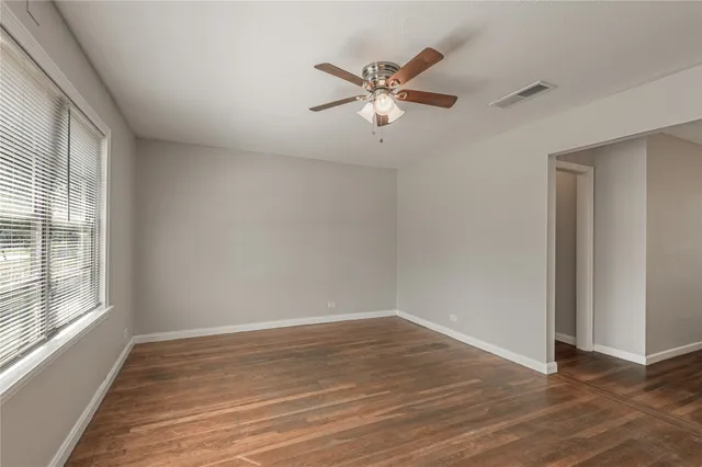 a view of a room with wooden floor and window