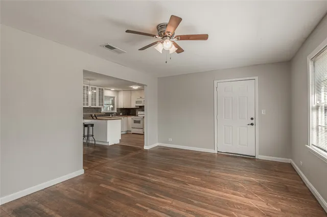 a view of kitchen with wooden floor and a window