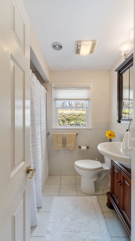 53 Cedarcrest Road Boston, MA 02132 - Photo 11 of 29 a bathroom with a toilet sink and mirror
