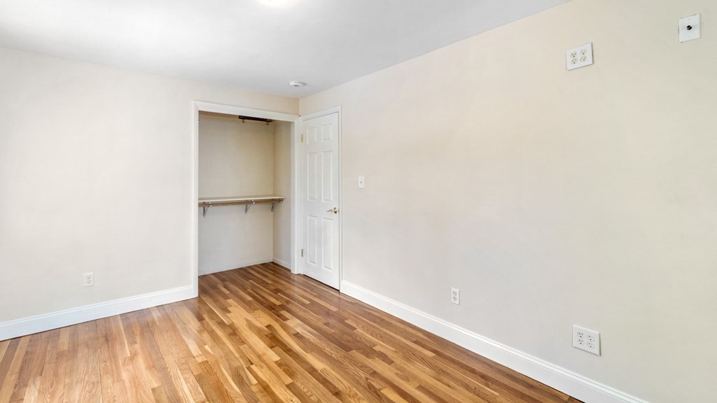 53 Cedarcrest Road Boston, MA 02132 - Photo 17 of 29 a view of empty room with wooden floor