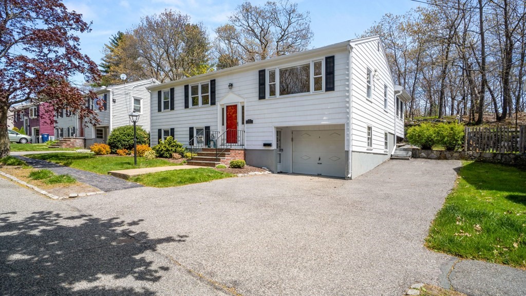 53 Cedarcrest Road Boston, MA 02132 - Photo 2 of 29 a view of a white house with a small yard and large trees