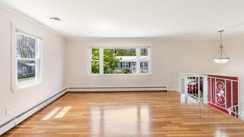 53 Cedarcrest Road Boston, MA 02132 - Photo 3 of 29 a view of an empty room with a window and wooden floor