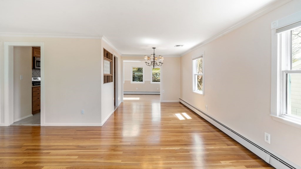 53 Cedarcrest Road Boston, MA 02132 - Photo 5 of 29 a view of an empty room with wooden floor and a window
