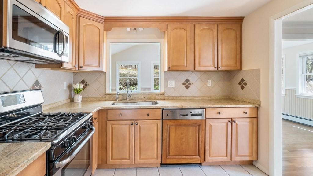 53 Cedarcrest Road Boston, MA 02132 - Photo 6 of 29 a kitchen with stainless steel appliances granite countertop a stove a sink and a microwave