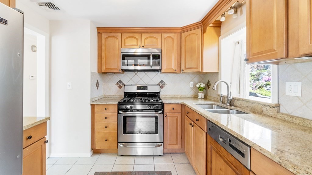 53 Cedarcrest Road Boston, MA 02132 - Photo 7 of 29 a kitchen with stainless steel appliances granite countertop a sink stove and microwave