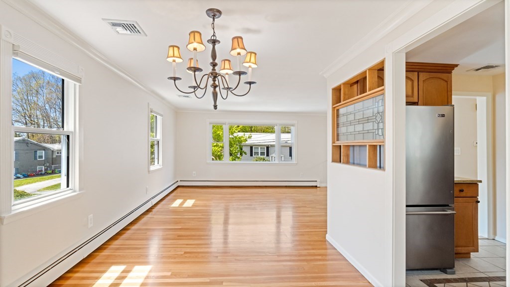 53 Cedarcrest Road Boston, MA 02132 - Photo 8 of 29 a view of a hallway with a dining table chairs and couches
