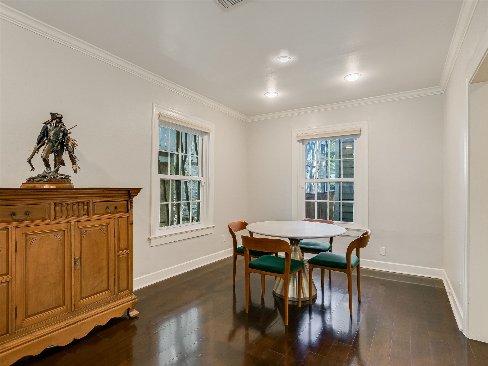 1804 Polo Road Austin, TX 78703 - Photo 9 of 19 Dining area featuring ornamental molding and dark wood-style floors