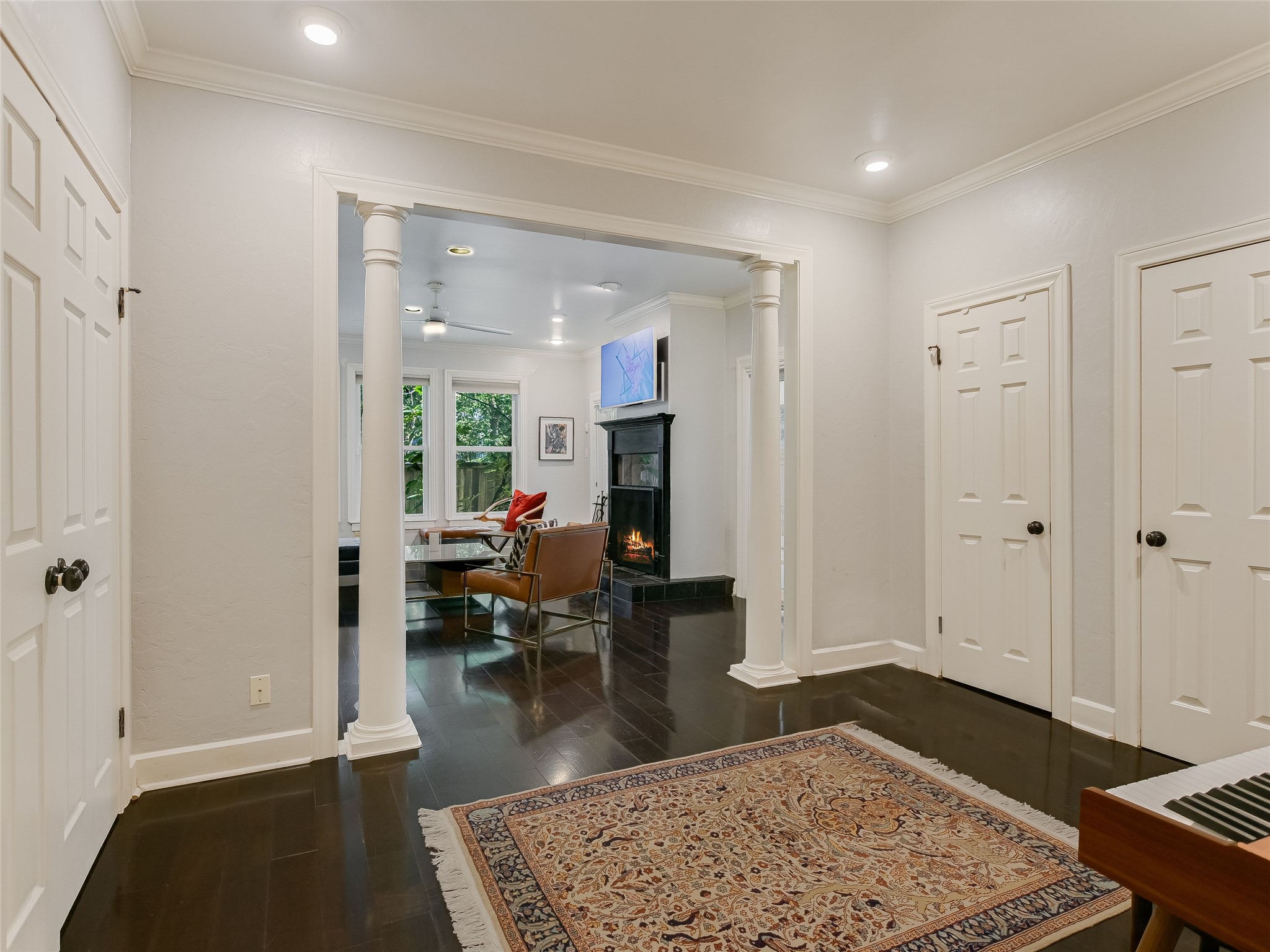 1804 Polo Road Austin, TX 78703 - Photo 10 of 19 Entryway with decorative columns, dark wood-style flooring, crown molding, a ceiling fan, and recessed lighting