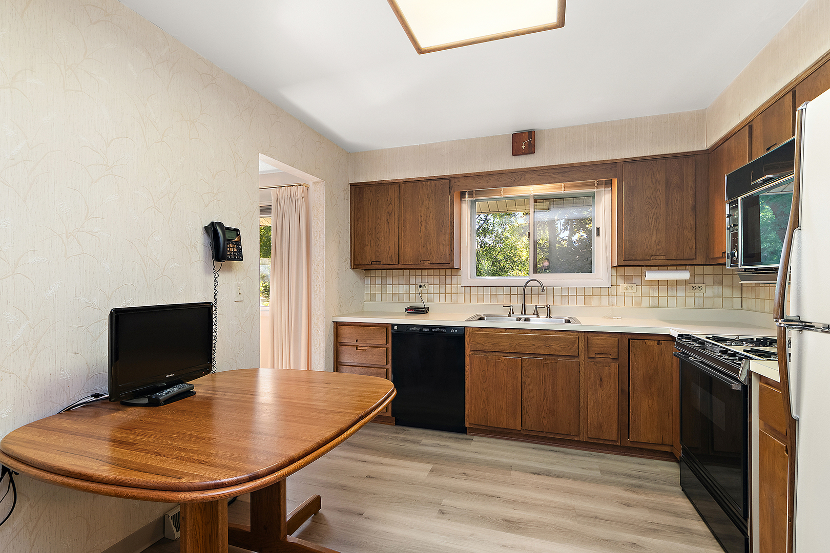 2 Vermont Circle Bolingbrook, IL 60440 - Photo 7 of 19 a kitchen with stainless steel appliances granite countertop a sink table and chairs