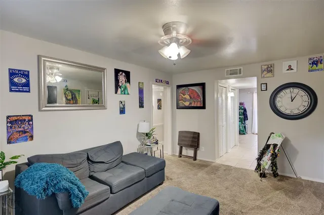 a living room with furniture a mirror and a flat screen tv