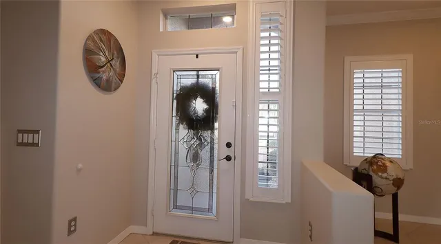 a view of a livingroom with a flesh screen tv and windows