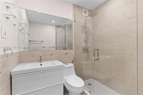 a bathroom with a toilet and a shower