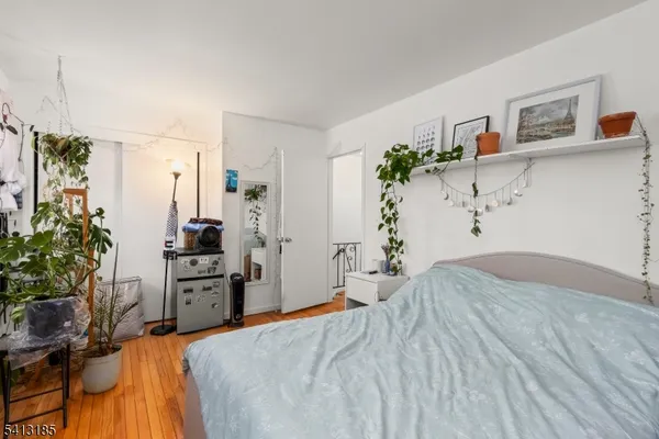 a bedroom with a bed and a potted plant