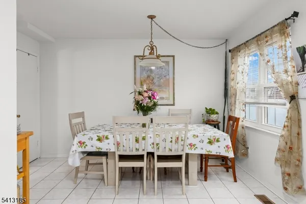 a dining room with furniture and window