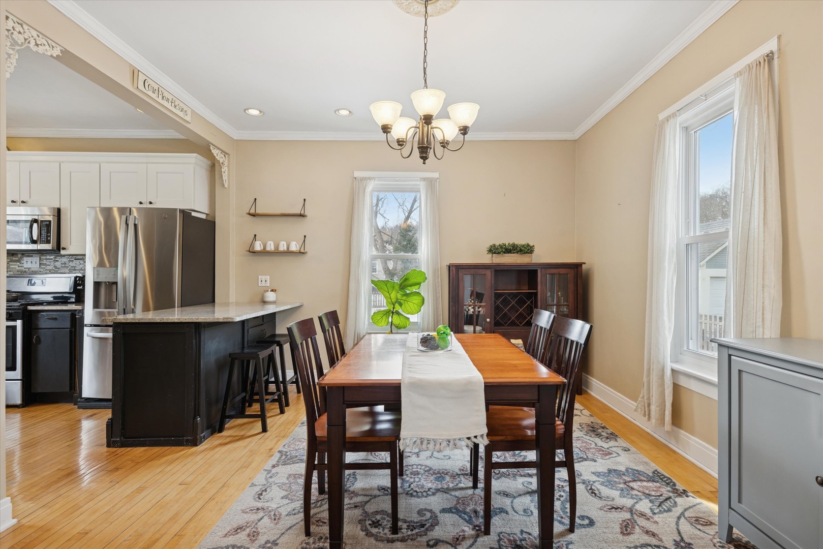 21 Division Street Algonquin, IL 60102 - Photo 8 of 20 a dining room with wooden floor a chandelier a wooden table and chairs