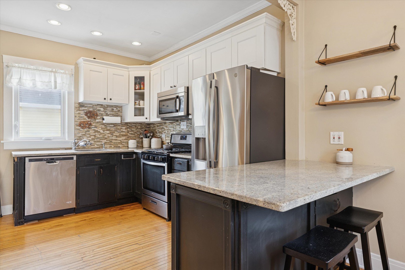 21 Division Street Algonquin, IL 60102 - Photo 9 of 20 a kitchen with stainless steel appliances a refrigerator a sink a stove and cabinets