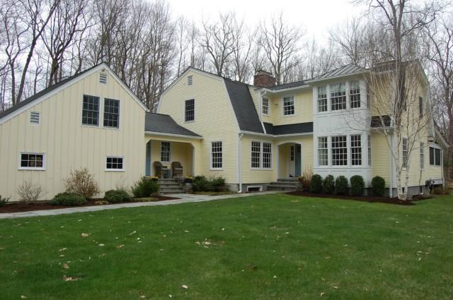 a front view of a house with a garden and yard