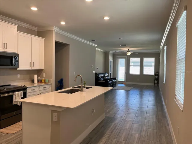 a kitchen with sink and cabinets