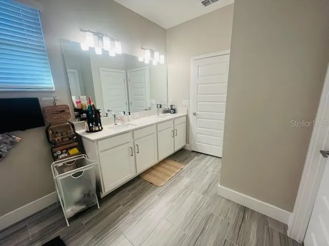 a view of a bathroom with sink and a hallway