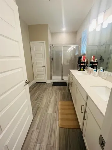 a bathroom that has a glass shower door
