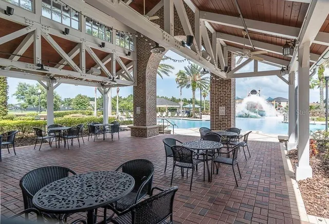 a view of a dining room with furniture wooden floor and a potted plant