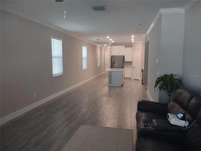 a living room with furniture and white walls