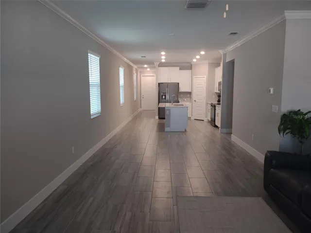 a lobby with furniture and a potted plant