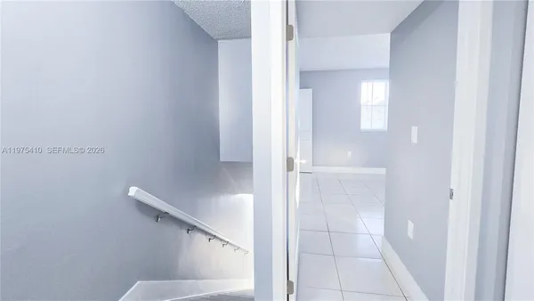 a view of a bathroom with a sink and a mirror