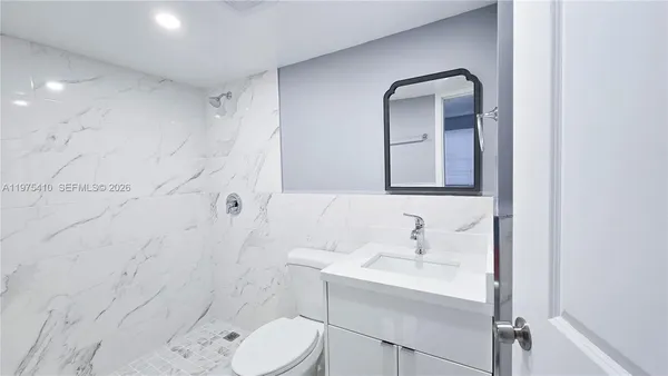 a bathroom with a sink toilet and shower