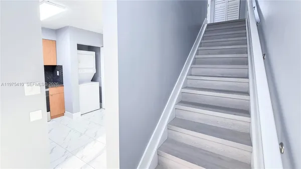 a kitchen with a refrigerator and a sink