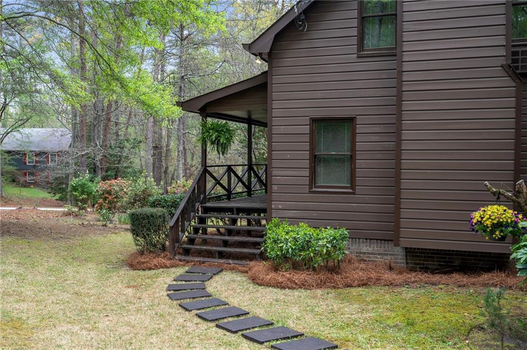 3121 Bonds Lake Road Northwest Conyers, GA 30012 - Photo 2 of 36 a front view of a house with garden