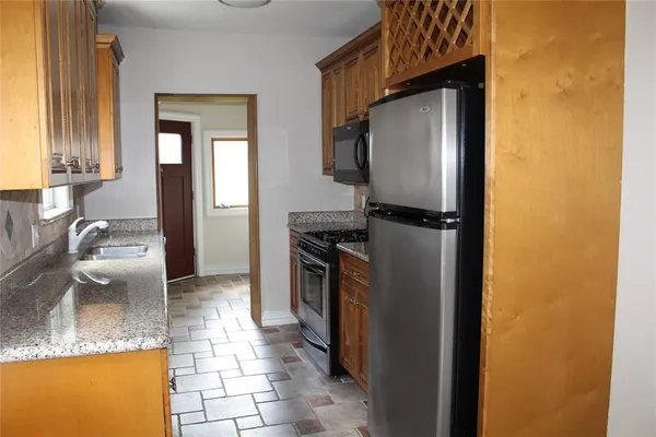 a kitchen with a refrigerator sink and stove