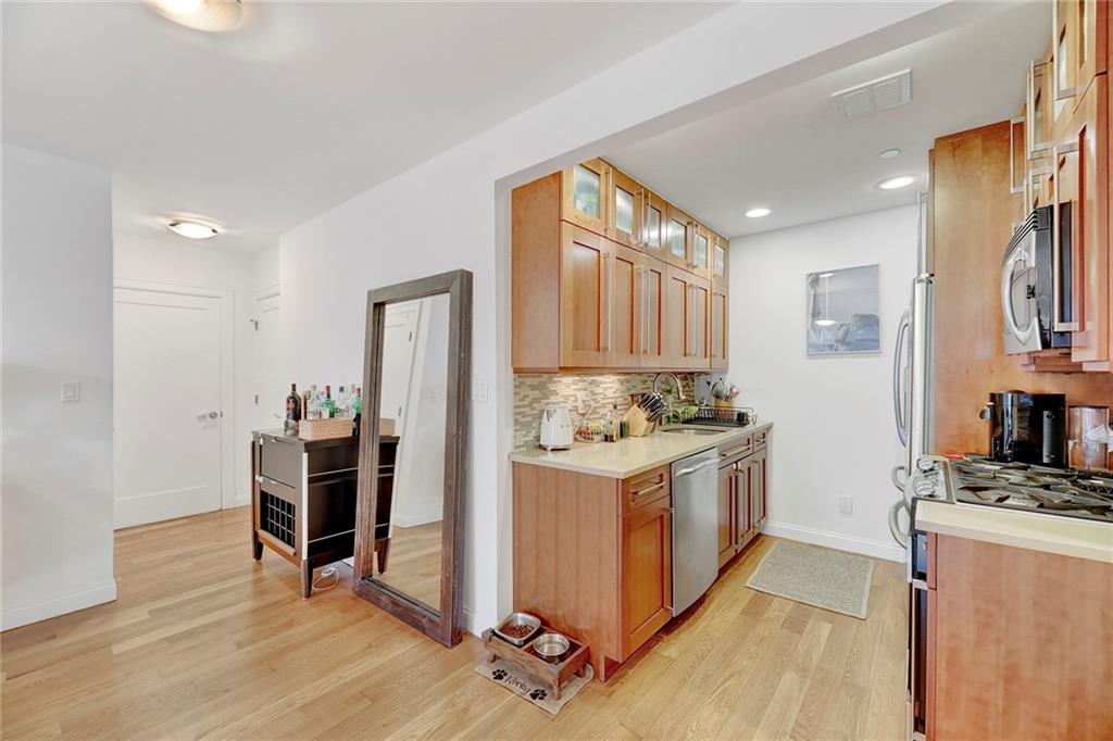 26 4th Street, Unit 2D Brooklyn, NY 11231 - Photo 11 of 26 a kitchen with stainless steel appliances granite countertop a stove and a refrigerator