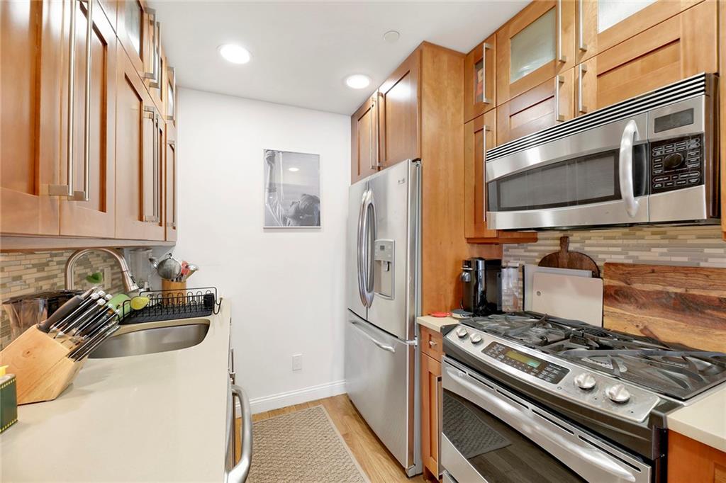 26 4th Street, Unit 2D Brooklyn, NY 11231 - Photo 13 of 26 a kitchen with stainless steel appliances a stove a sink and a refrigerator