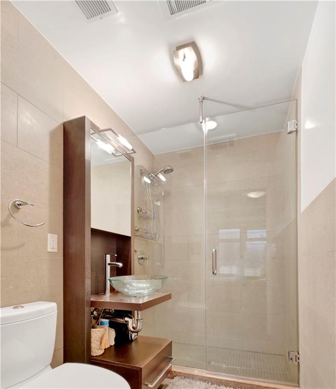 26 4th Street, Unit 2D Brooklyn, NY 11231 - Photo 18 of 26 a bathroom with a sink toilet and shower