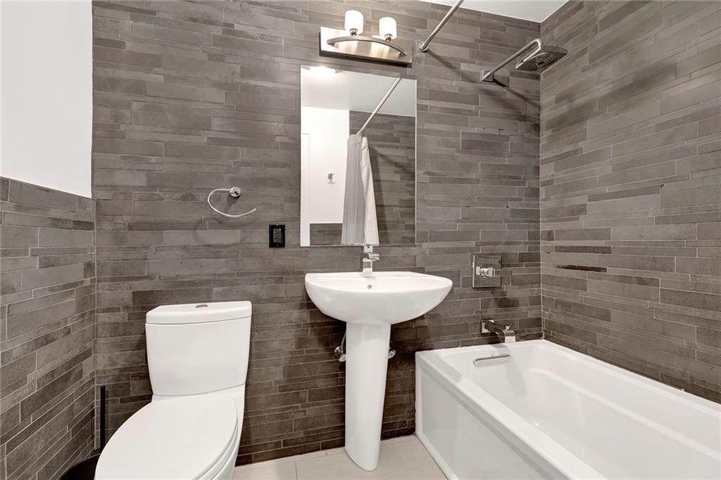 26 4th Street, Unit 2D Brooklyn, NY 11231 - Photo 22 of 26 a bathroom with a sink a toilet and bathtub