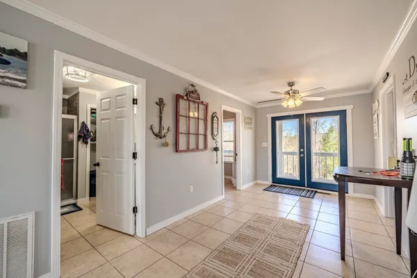 a view of a livingroom with wooden floor and a kitchen