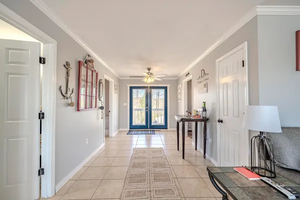 a view of a hallway with furniture and a window