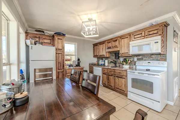 a kitchen with stainless steel appliances kitchen island granite countertop a stove and a refrigerator