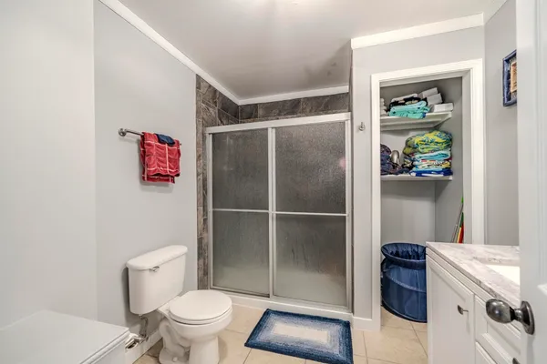 a bathroom with a toilet and a shower