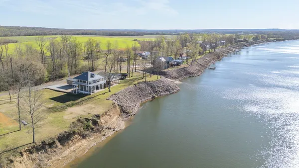 a view of a patio with table and chairs wooden floor and fence