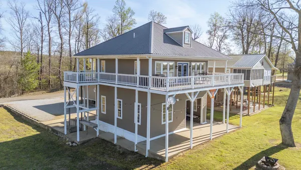 a view of a house with backyard porch and sitting area
