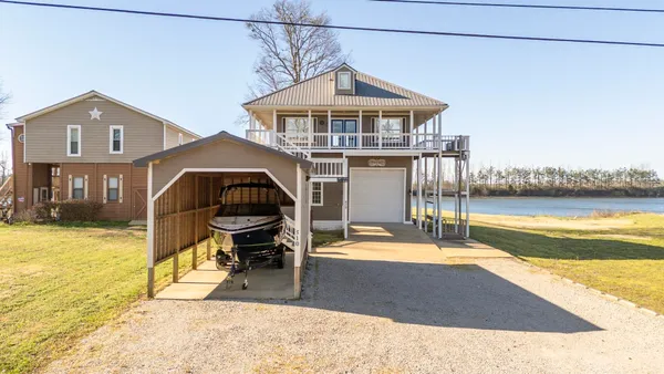 a view of a house with swimming pool and sitting area