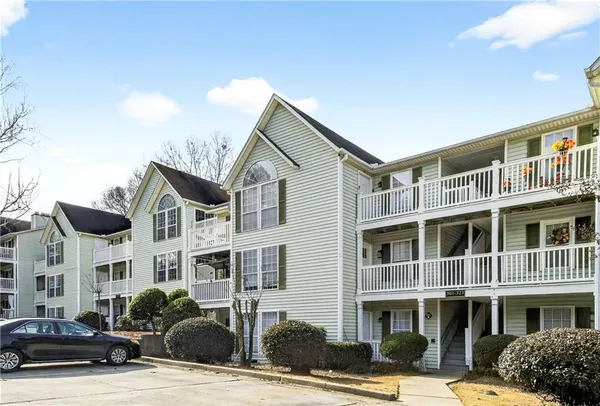 a front view of a residential apartment building with a yard