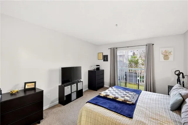 a bedroom with furniture and a flat screen tv