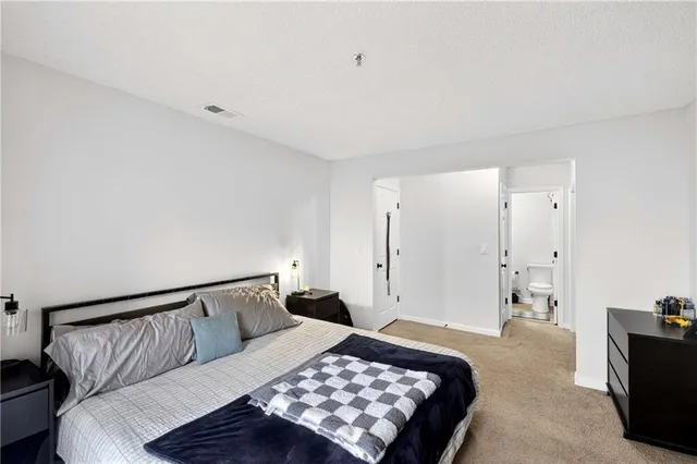 a bed room with a bed and a television