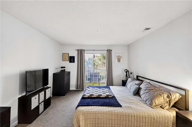 a bedroom with a bed and a television