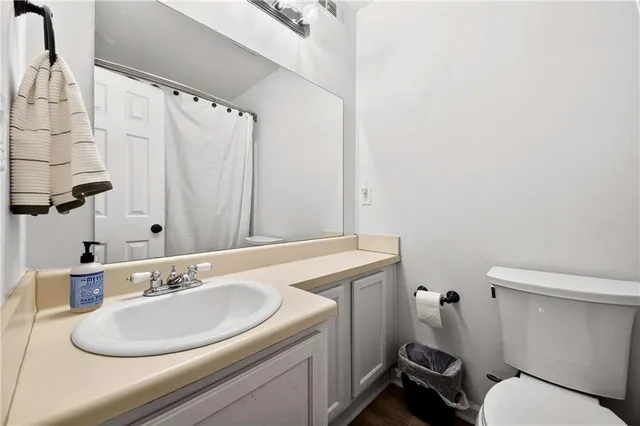 a bathroom with a sink toilet and a mirror
